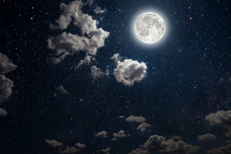 The night sky of with a full Moon, stars and some cloud